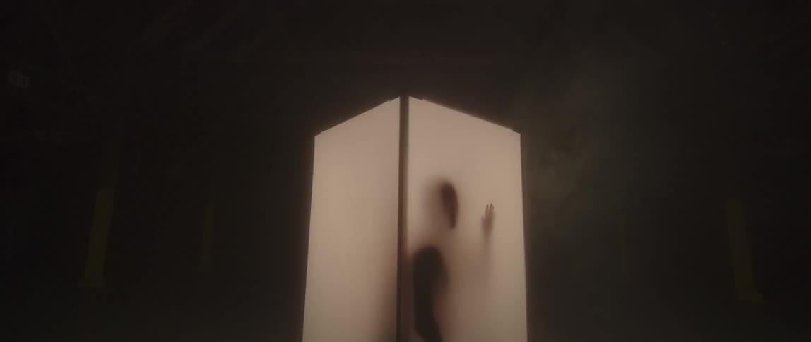 A person is in a white lit box