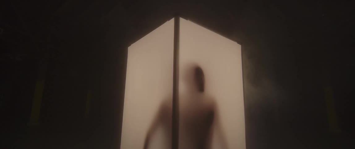 A man traces his hands around the box he is trapped in