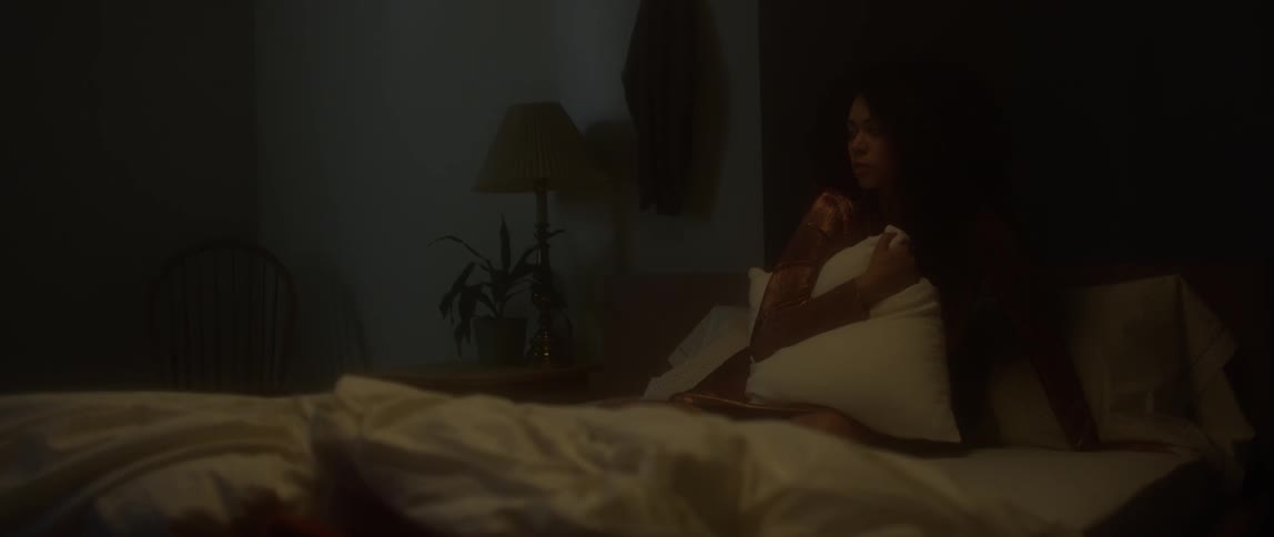 A woman is laying in bed holding a pillow