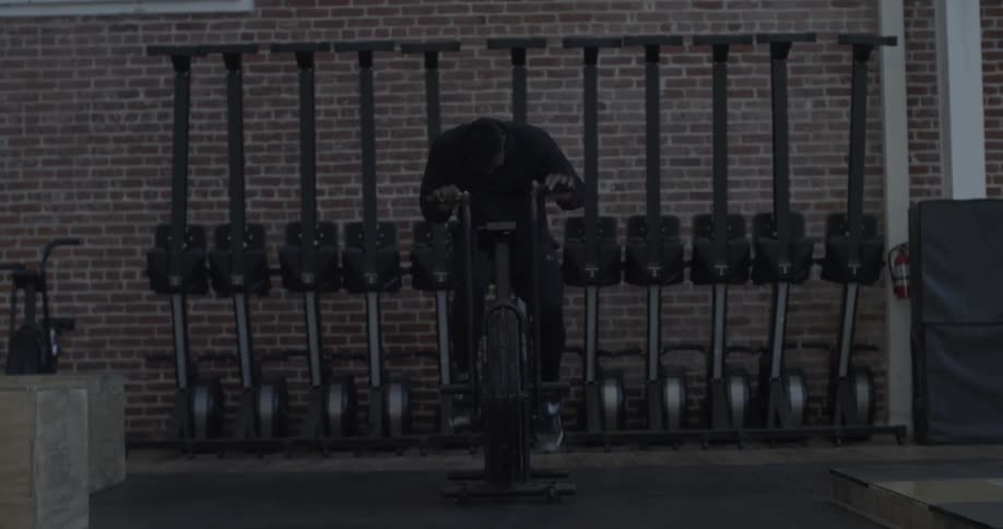 A man is riding an exercise bike