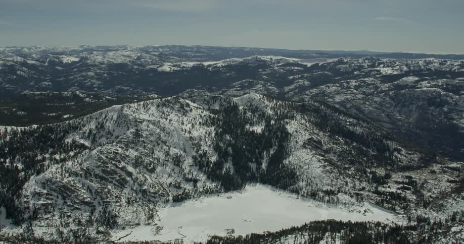 Snow covers a valley in a mountainous landscape on a sunny day in Lake Tahoe, California