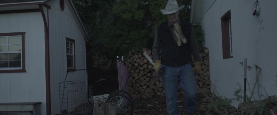 A man grabs a hatchet and walks away