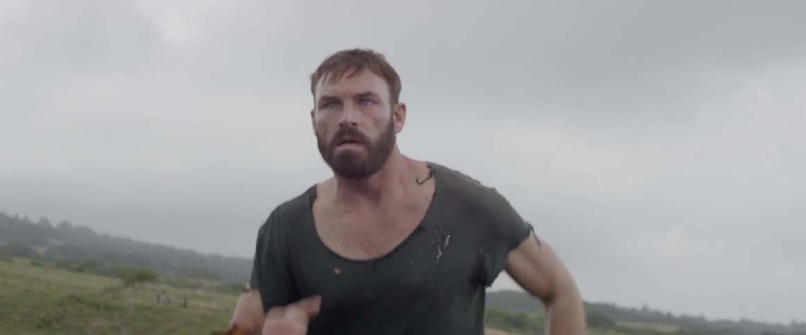 A man in a torn shirt is running away from something