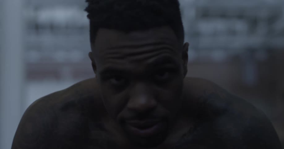 A man leaning forward looks up