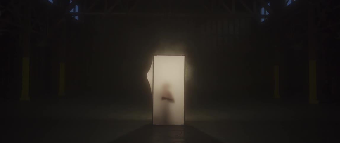 A man is kneeling in a small box
