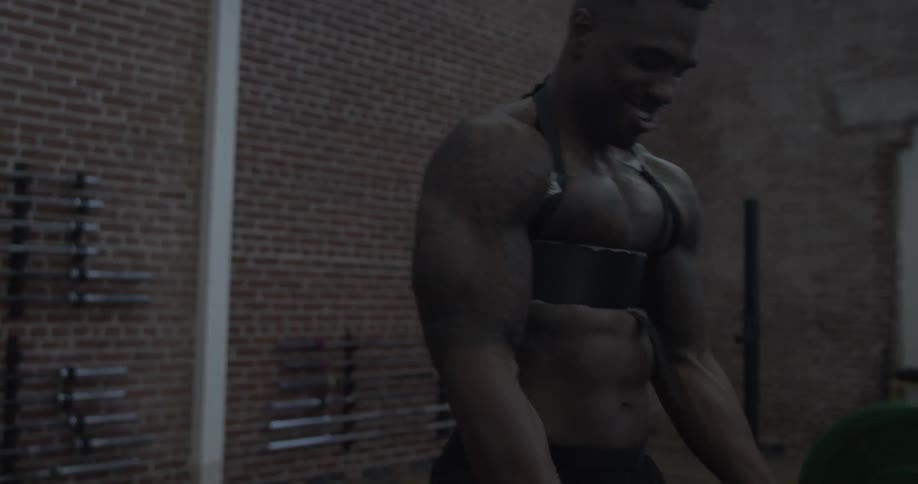 Man lifts a large barbell