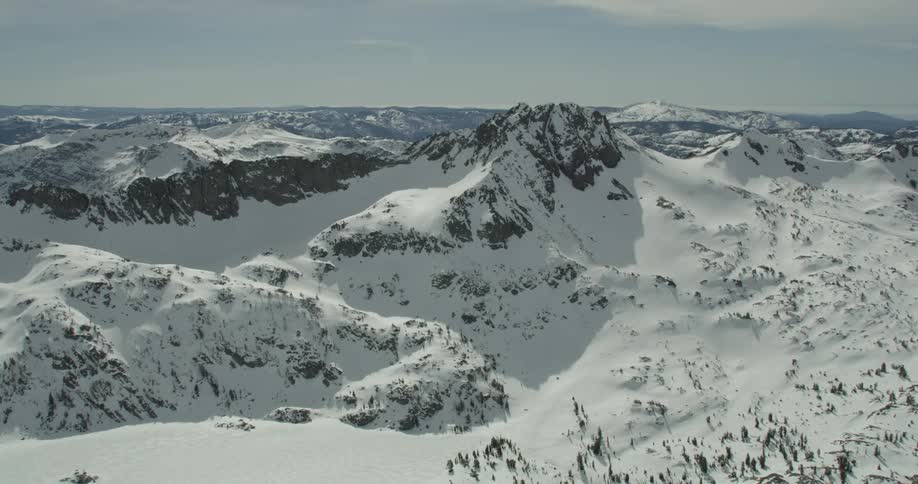 Snow covers the slopes of a mountain range