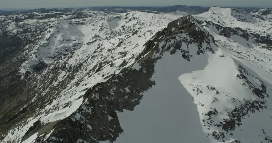Aerial view of snow covered mountains on a sunny day in Lake Tahoe, California