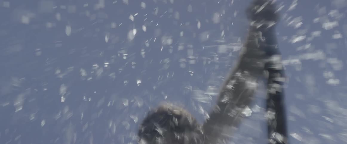 A man paddles in the water frantically