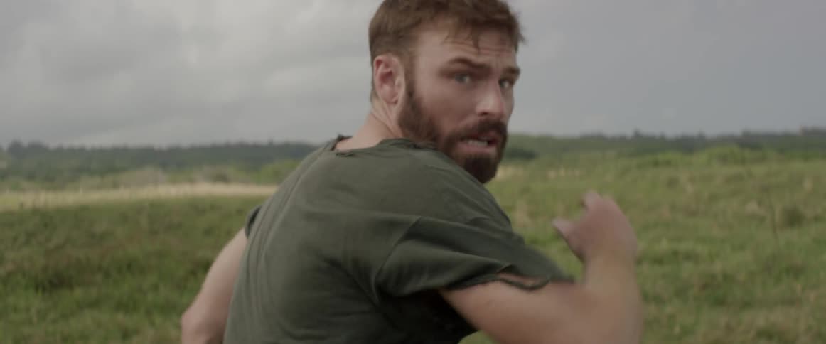 A man runs frantically through a field