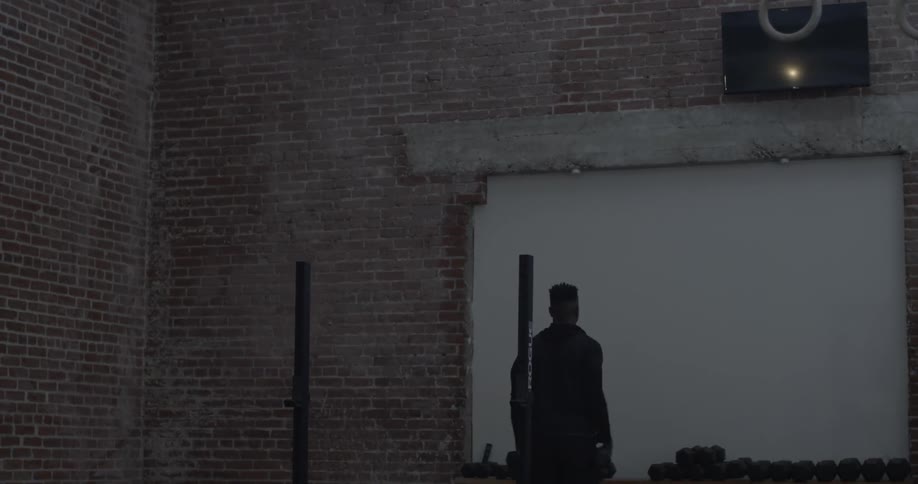A man lifts weights in a gym