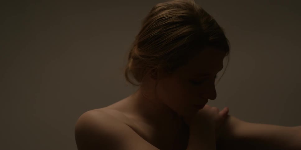 Woman touches her shoulders and hair