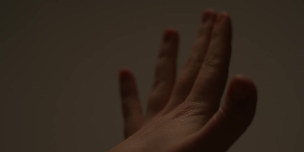 A woman opens and closes her hand