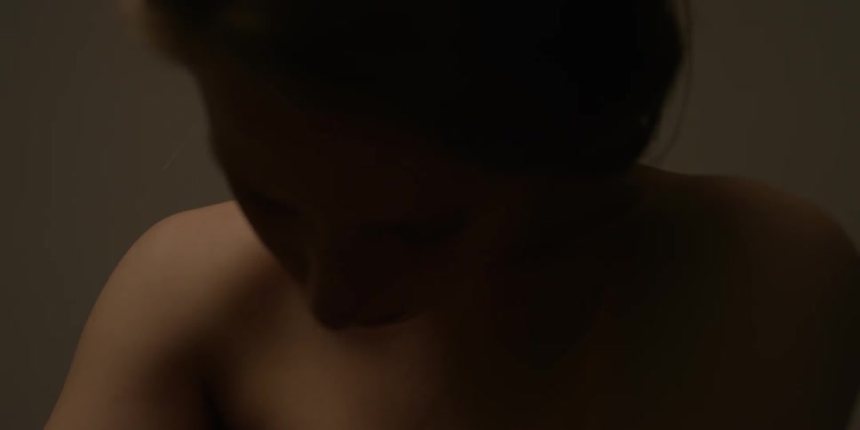 A naked woman is rolling her head and neck