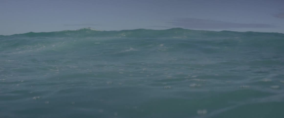 Waves roll and crash in the ocean during the day