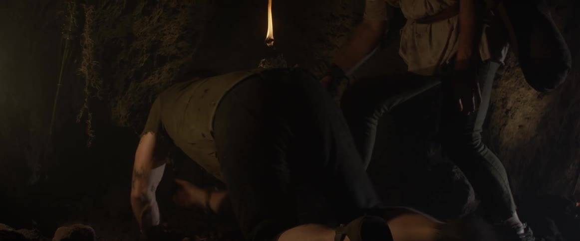 An elderly man tends to a hurt young man