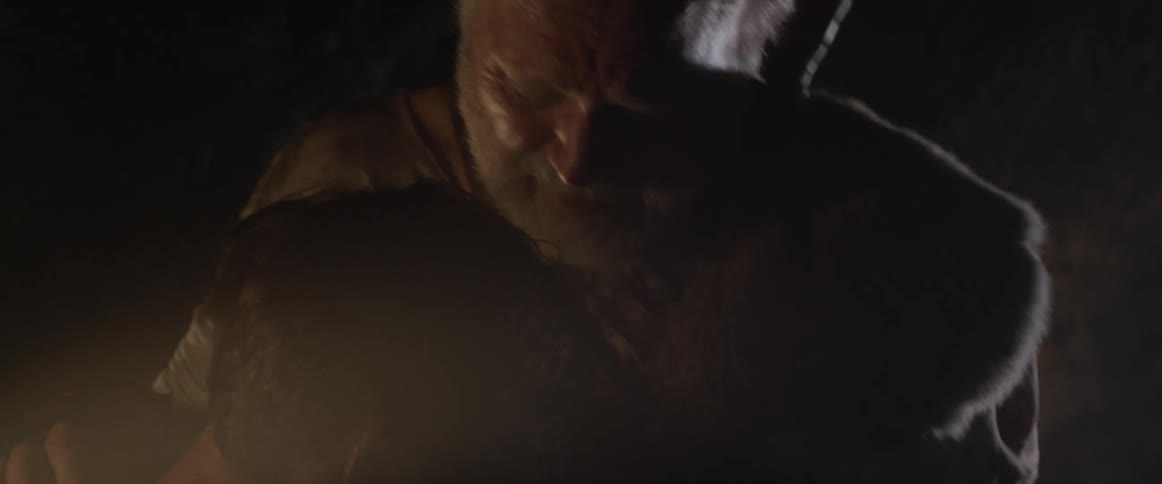 Two men in a dimly lit room