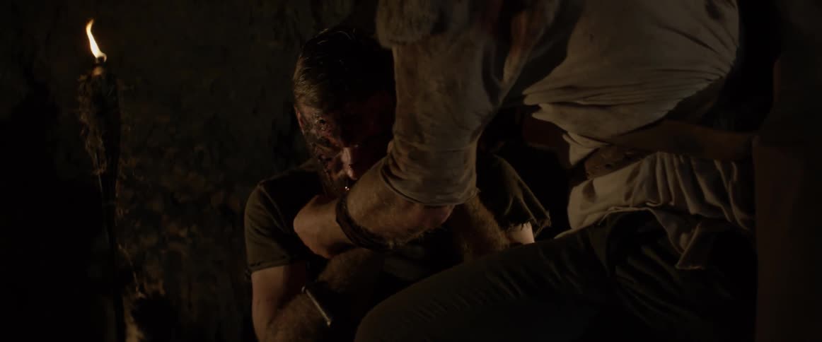 Man helps another man who is covered in blood