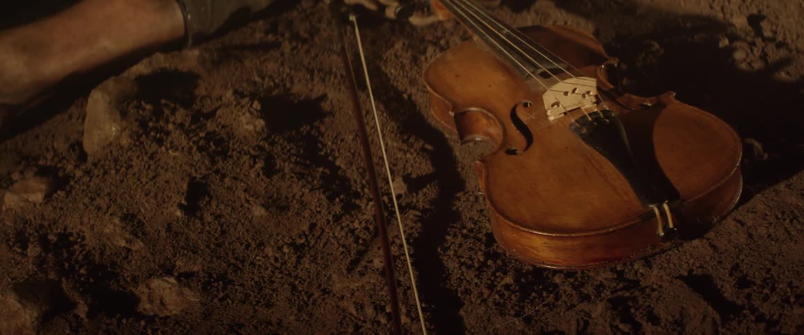 A violin is sitting on the ground