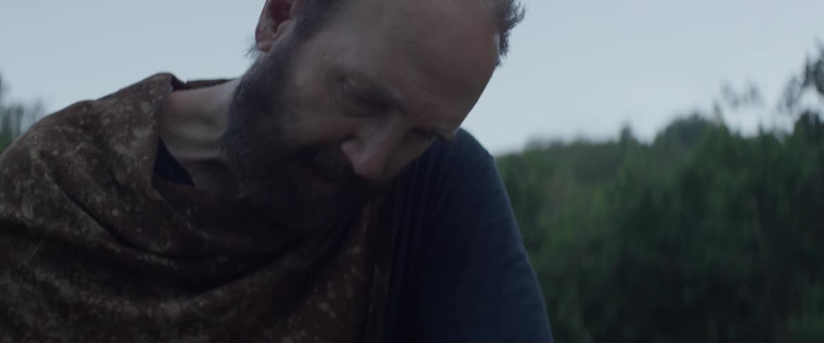 A man sands a piece of wood
