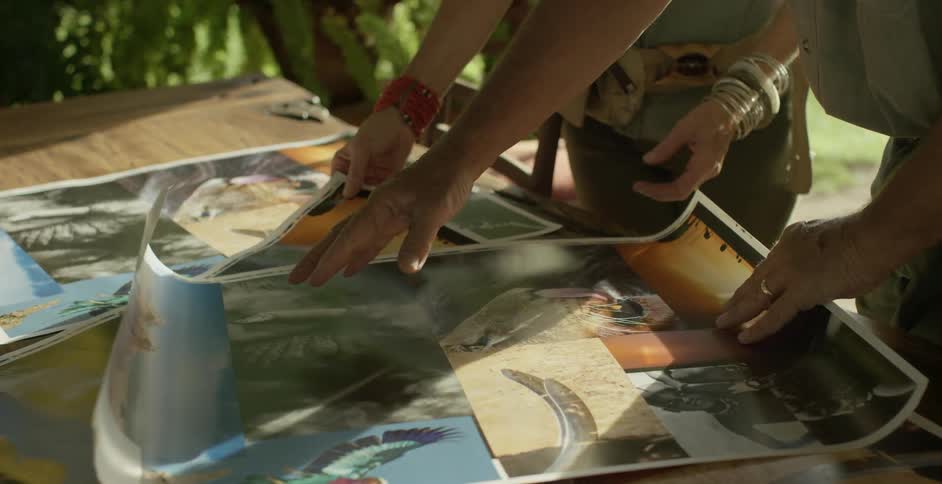 People roll out photographs to examine them