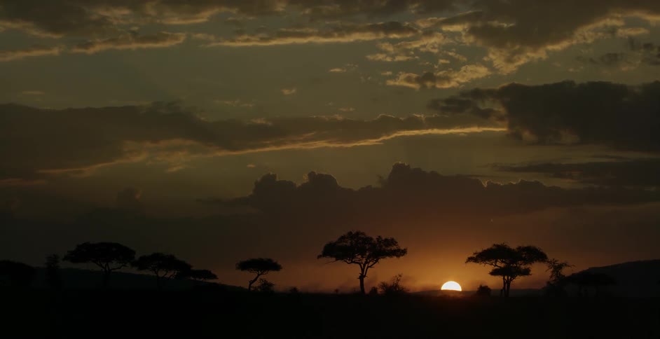 The sun sets above a hill
