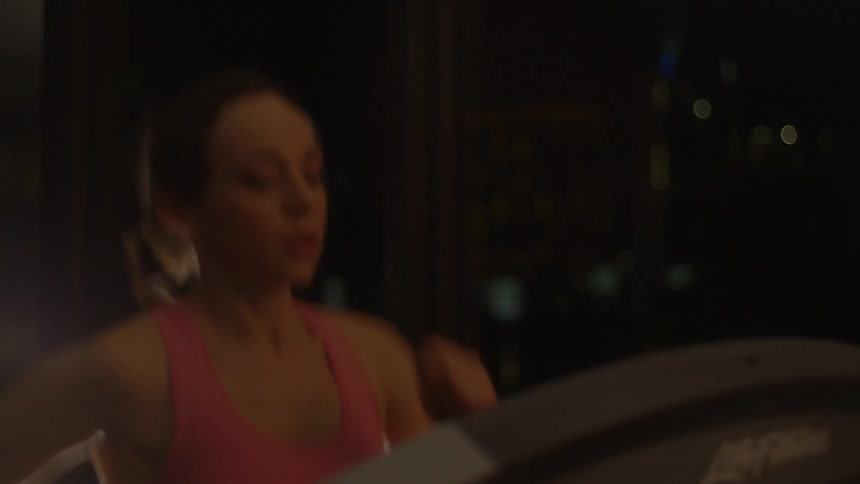 A woman runs on a treadmill