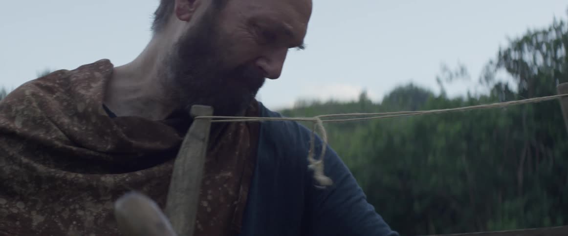 A man is using an old fashioned saw