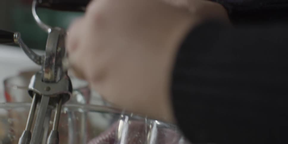 Woman cracks eggs into bowl