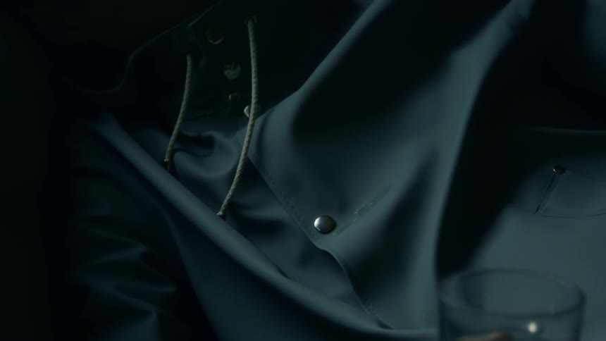 A droplet of water runs down the front of a jacket