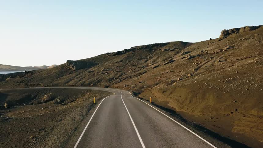 A road near some hills in Iceland