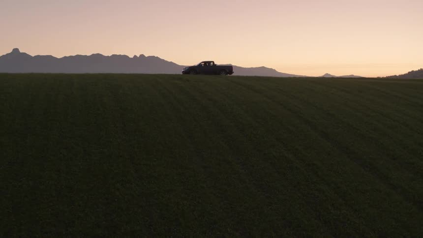A truck sits parked atop a hill
