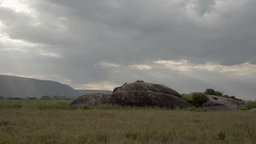 Hills and a grassy field on a cloudy day