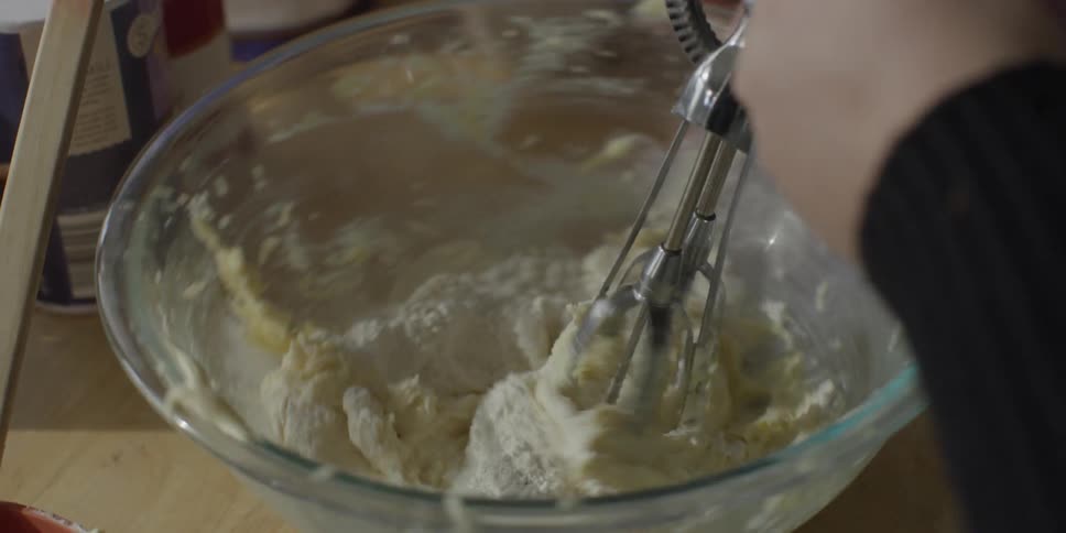 Flour is whisked into a bowl