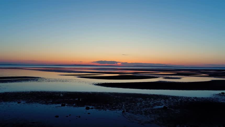 The sun sets over a marsh