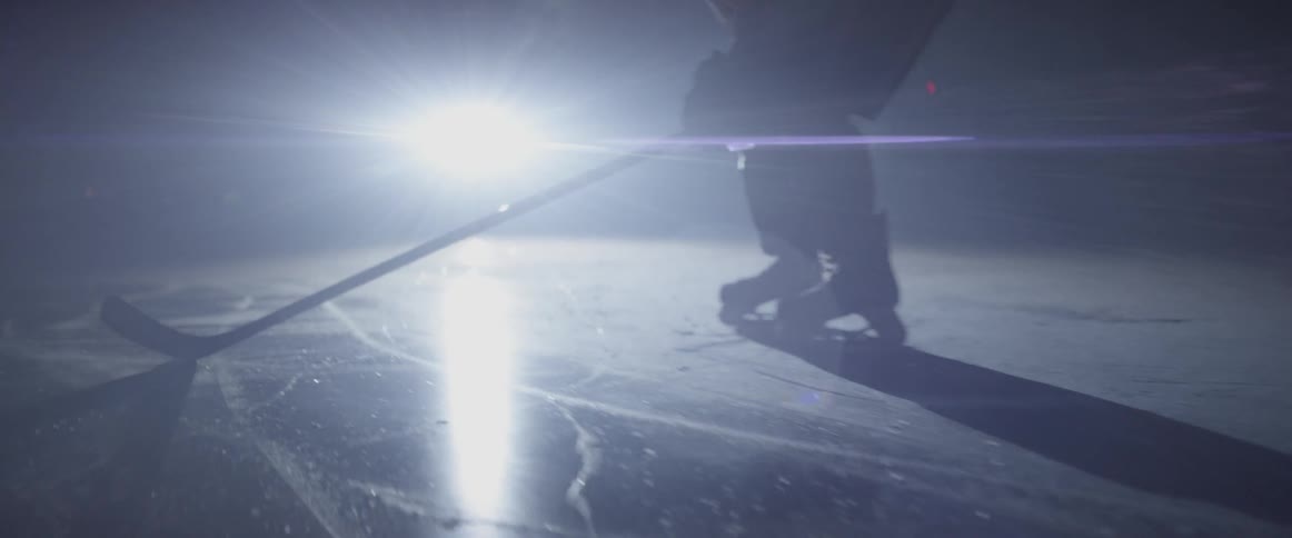 A hockey player stands on an ice arena