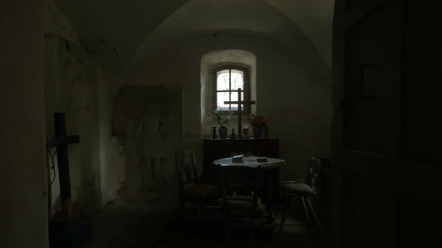 A few crosses are on display in a small stone room