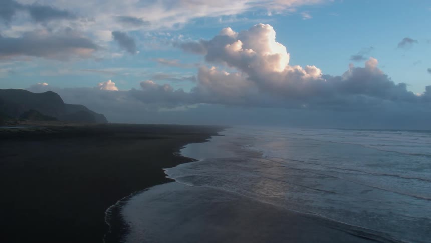 Ocean waves wash ashore a sandy beach