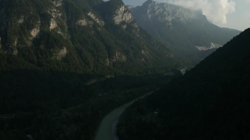A river sits between two mountains