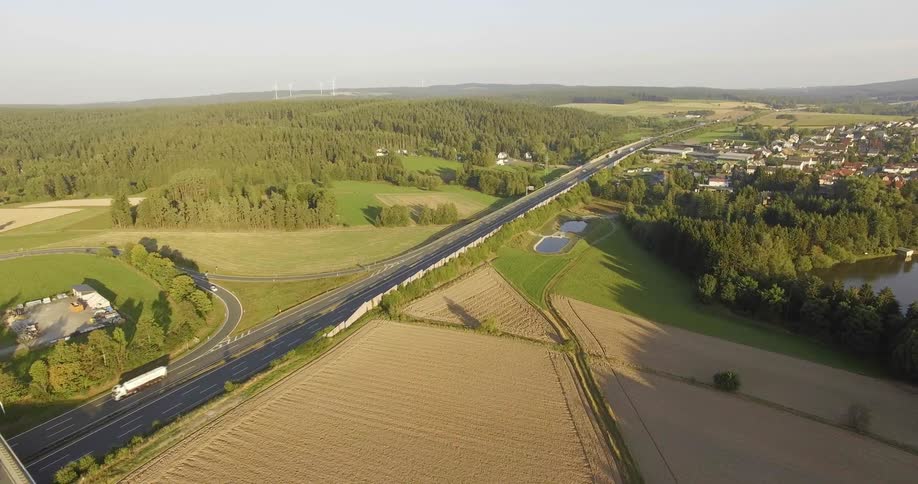 Cars and buses travel over the highway