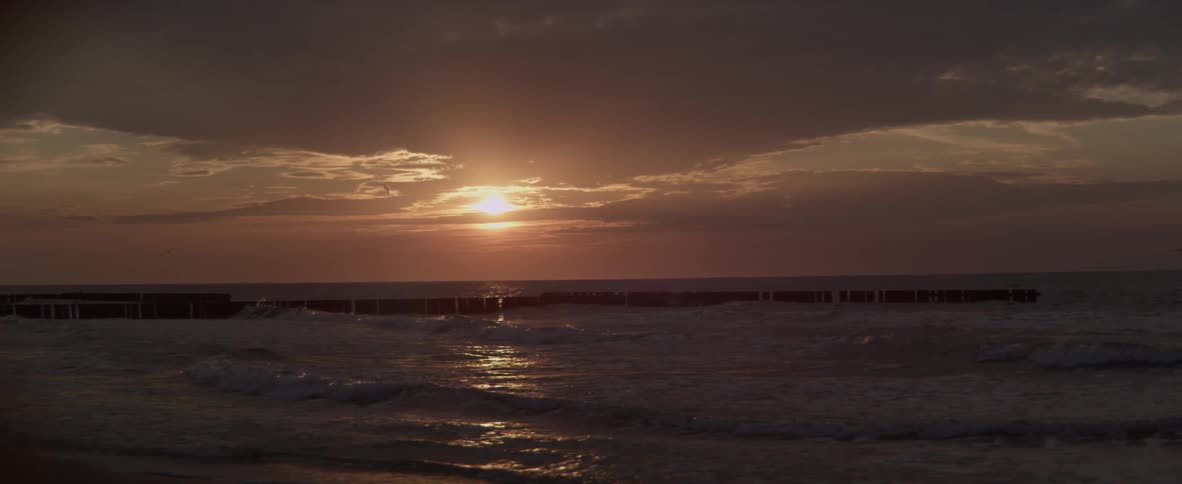The sun sets over the ocean
