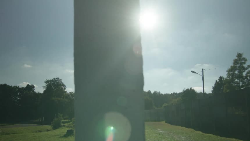 A large wall sits in the middle of the grass