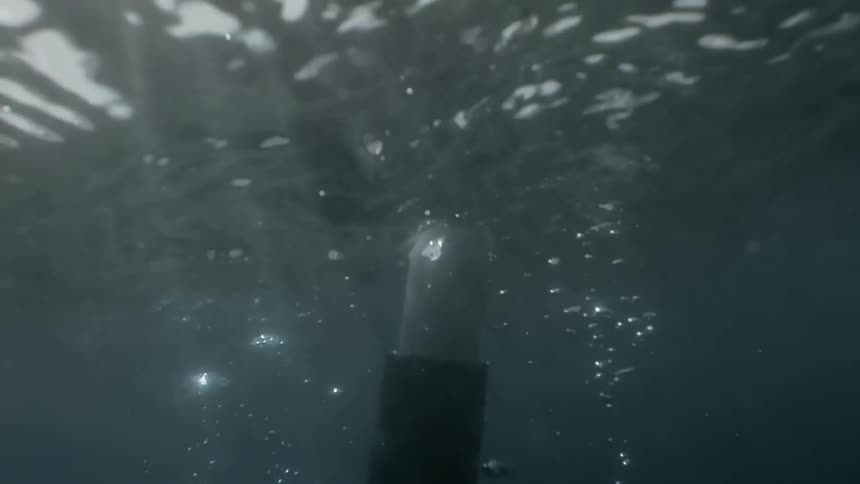 An oar cuts through the water