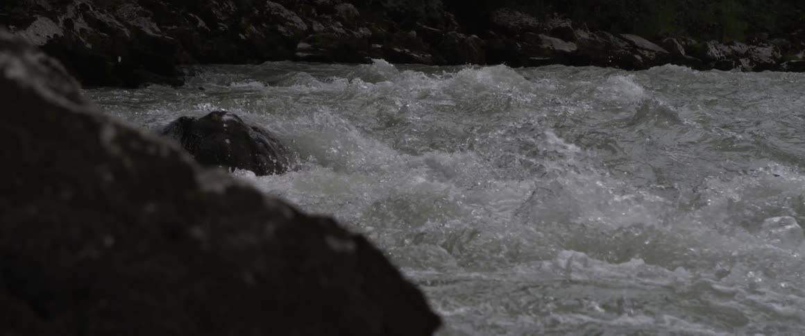 Water rushes and splashes in a river