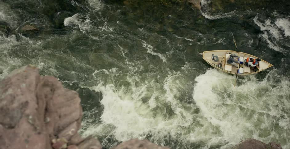 A boat is navigating some rapids