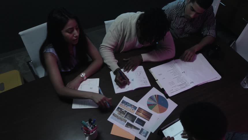 Some young people are having a meeting at a table