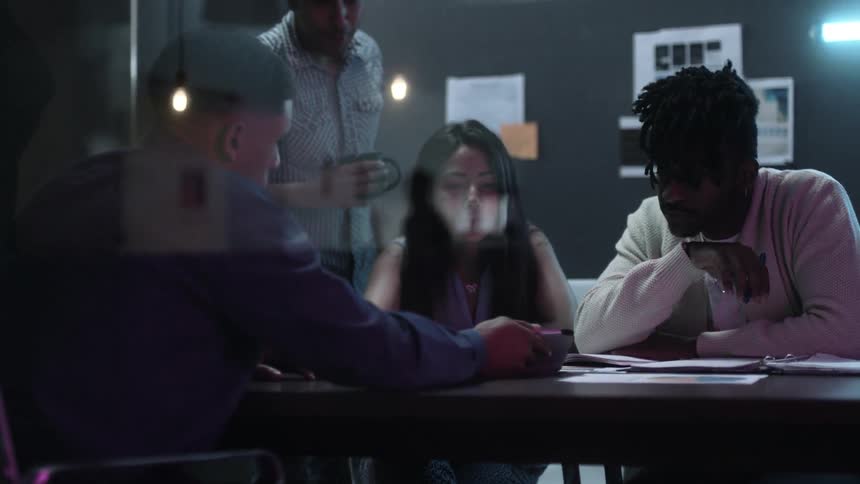 Workers in an office work together at a table