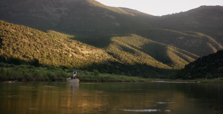 A boat is paddled down a calm river