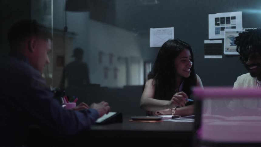 A team of employees gathers around a table