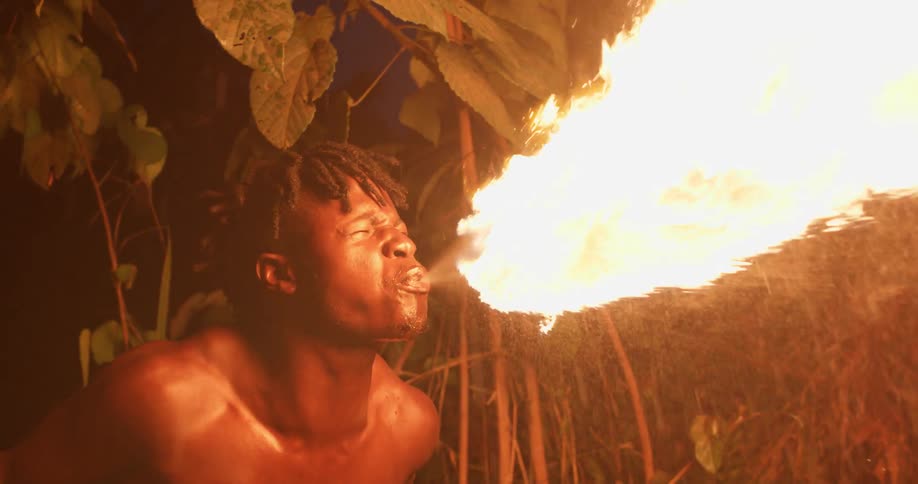 A man ignites a torch with liquid from his mouth